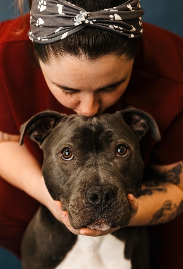Vet staff kissing a dog